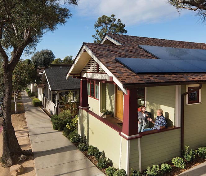 Couple On Patio With SunPower Panels On Their Home